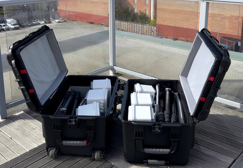 Two open Laran Flyaway Kit cases containing sensors and tripods